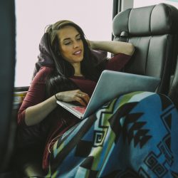 Person relaxing inside a Greyhound bus (USA).