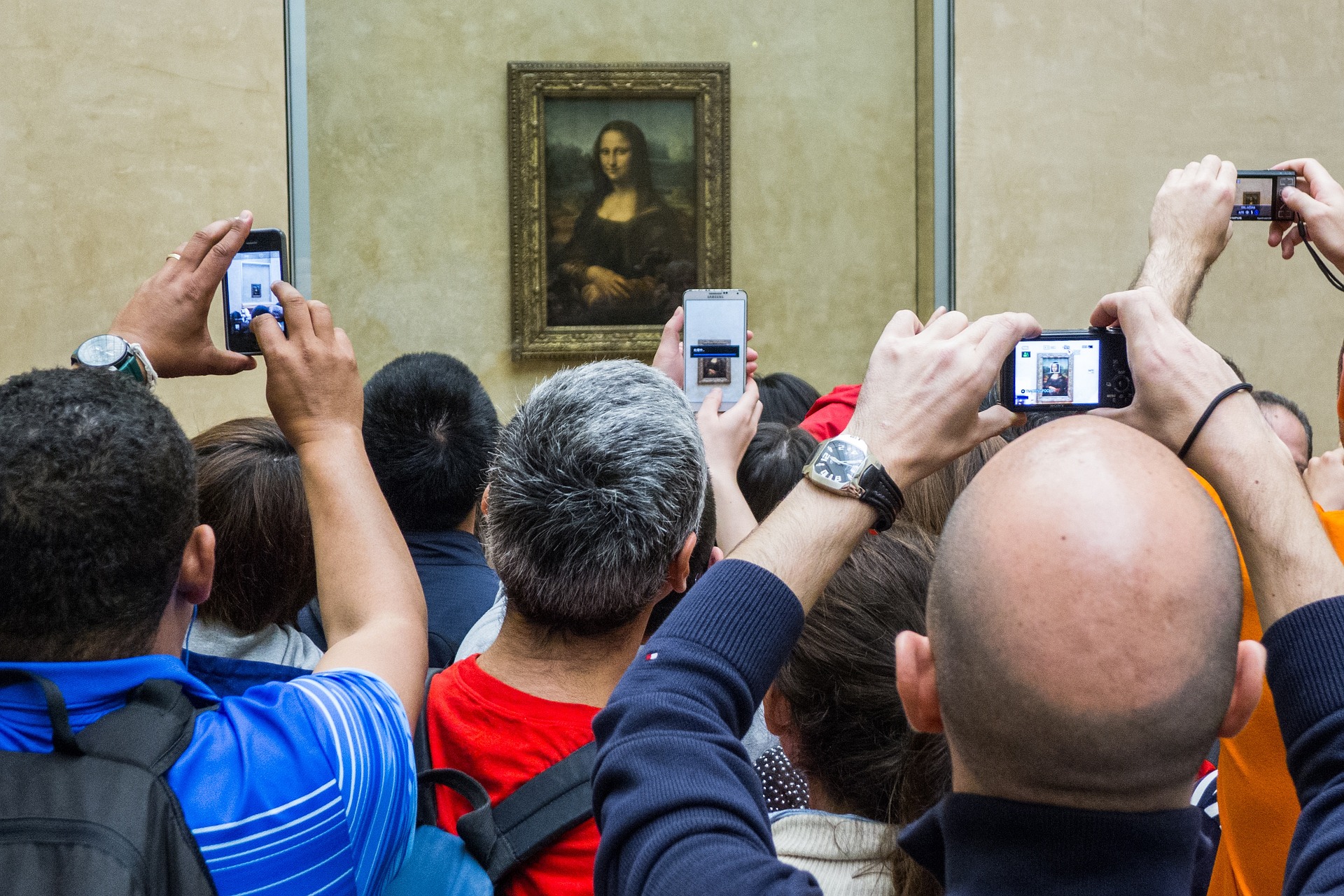 Crowds taking photos of Mona Lisa at the Louvre, Paris