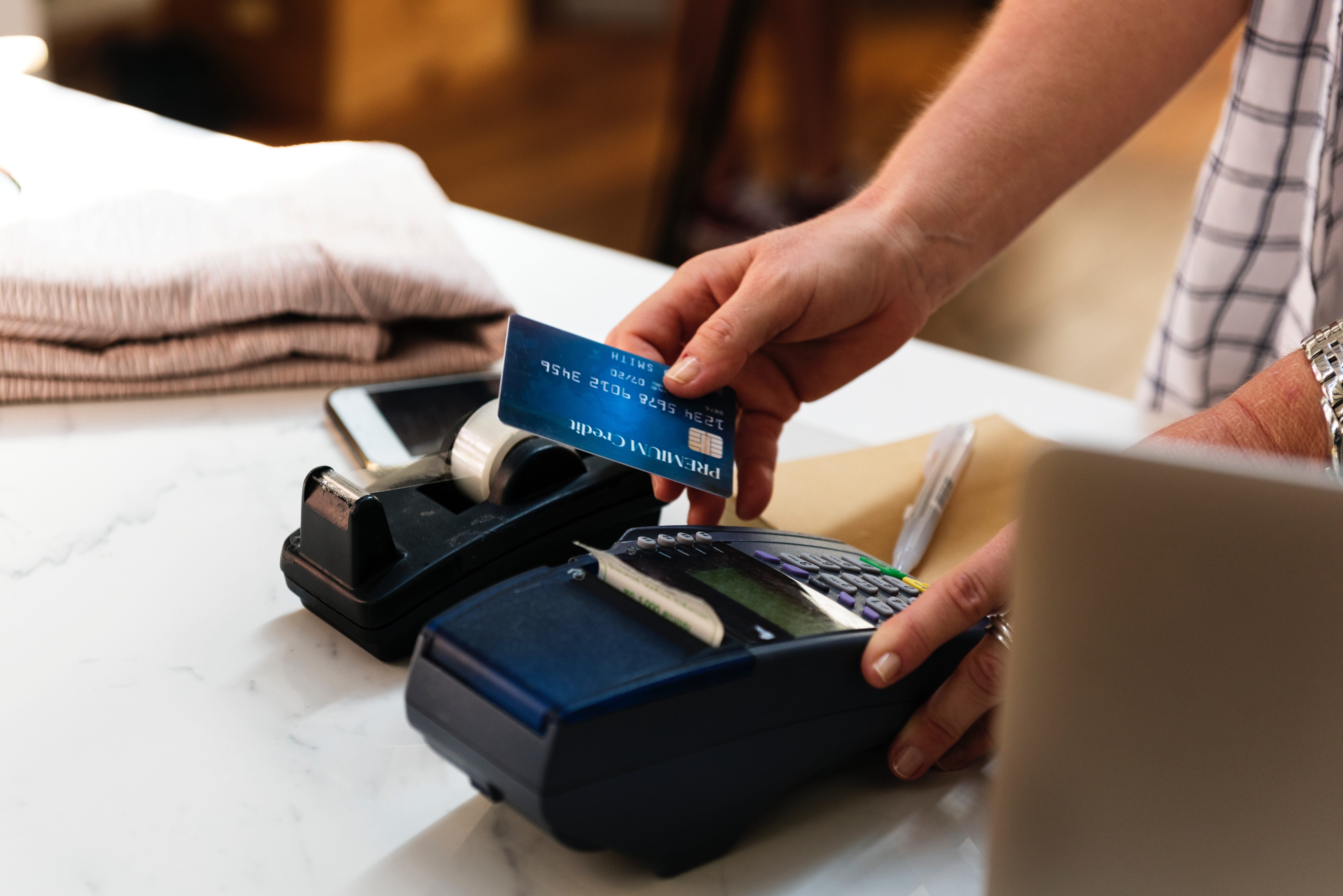 hand scanning a credit card through a reader