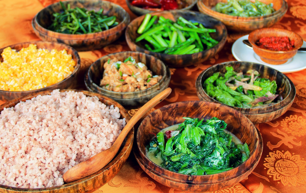 Bowls of food, red rice, curry in Bhutan