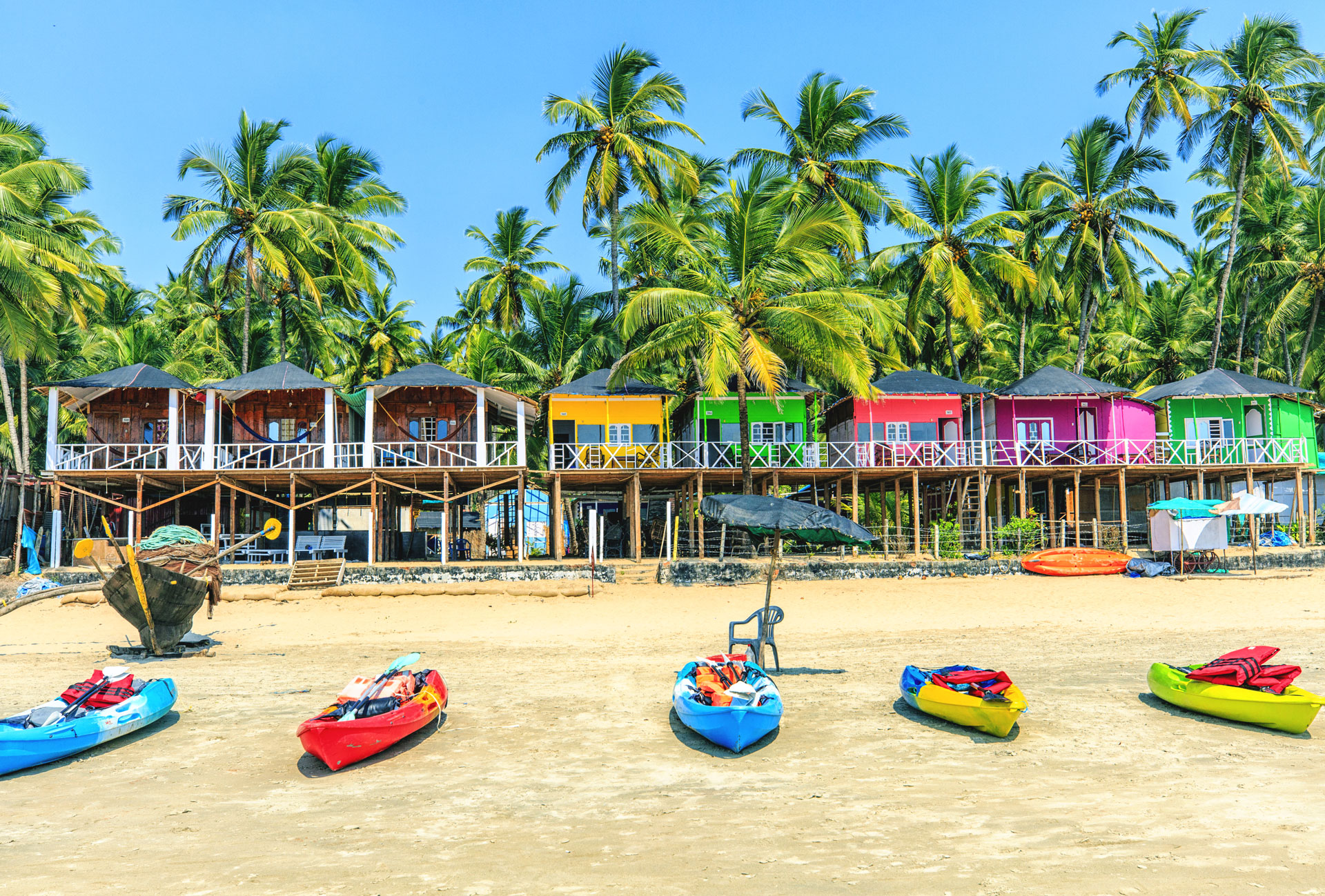 Colourful bungalows on Palolem beach Goa India